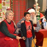 Seven-year-old Jeven Castaneda visits with Santa Claus and Mrs. Claus during Friday's "Reason for the Season."